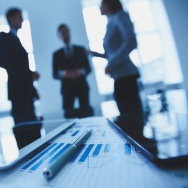 financial-report-with-co-workers-blurred-background